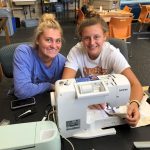 Picture of two students working with a sewing machine in the Innovation and Collaboration Studio
