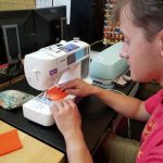 Picture of a student using a sewing machine in the Innovation and Collaboration Studio