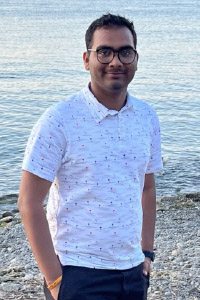 Jagrat Patel standing along a shoreline